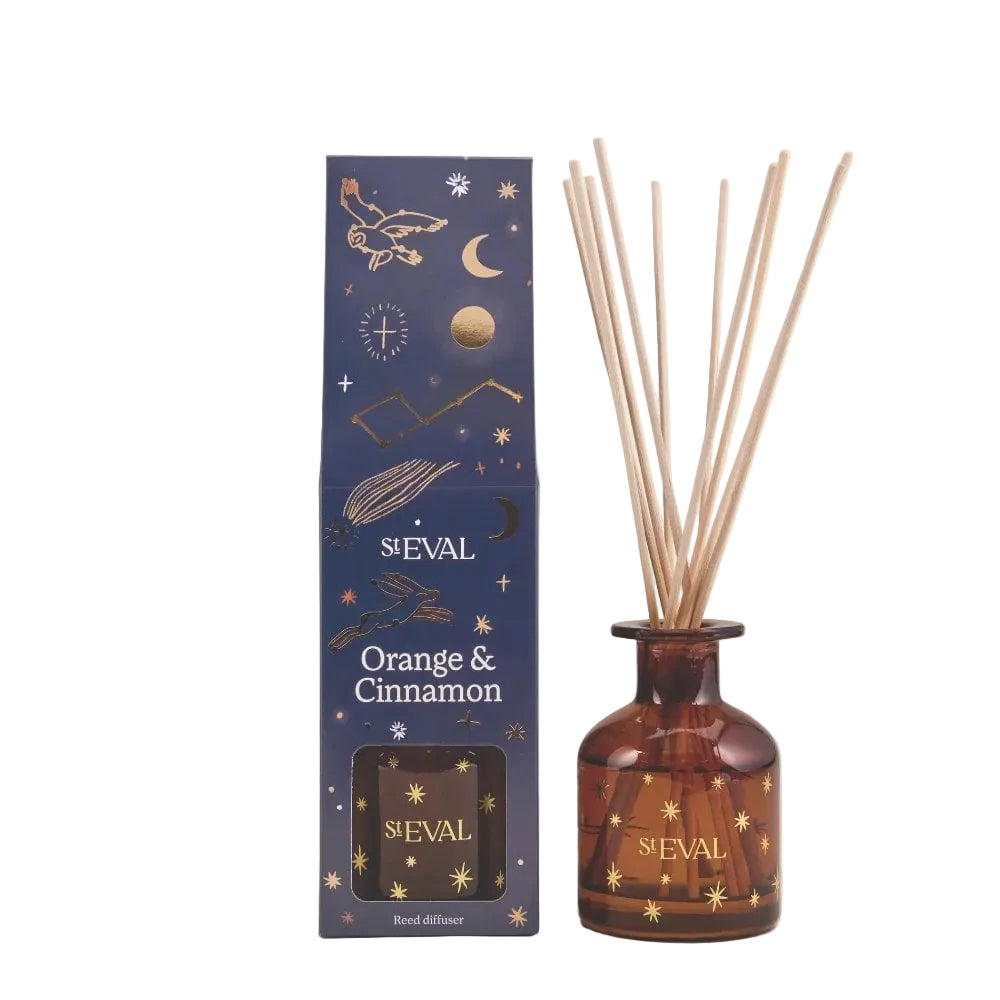 S'Eval Orange & Cinnamon reed diffuser set with a dark blue patterned box and an amber glass bottle containing reeds, on a light beige background.