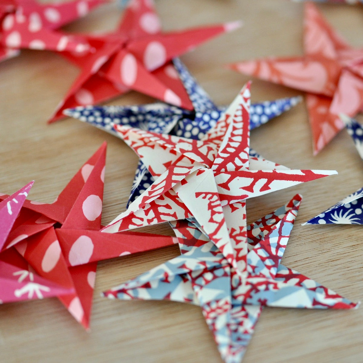 Colorful paper stars on a wooden surface