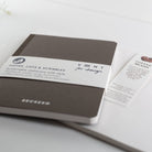 Brown notebook with a label on a white surface