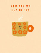 Illustration of a smiling tea cup with flowers and text 'You are my cup of tea' on a beige background