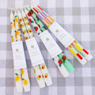 Set of colorful candles with decorative designs on a checkered background