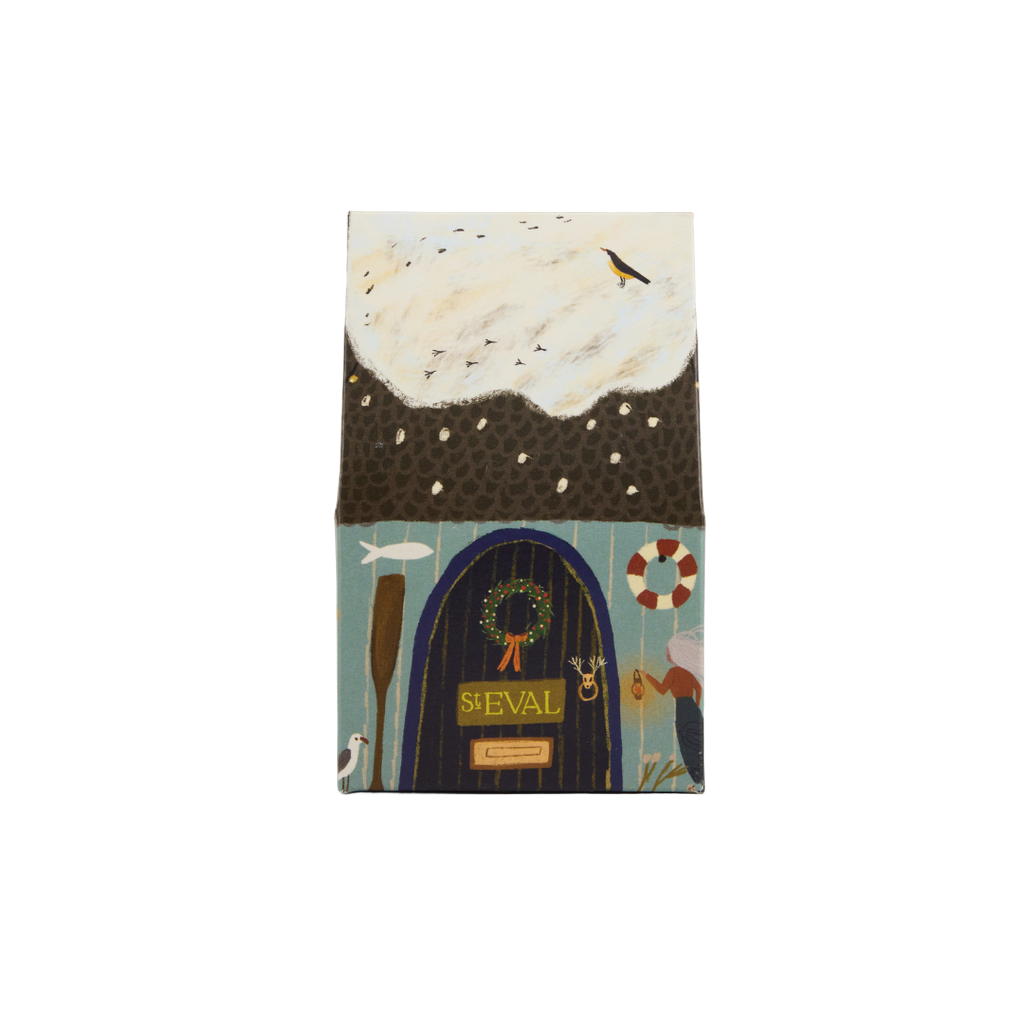 Notebook with a decorative cover featuring a house, boat, and nature elements on a plain background.