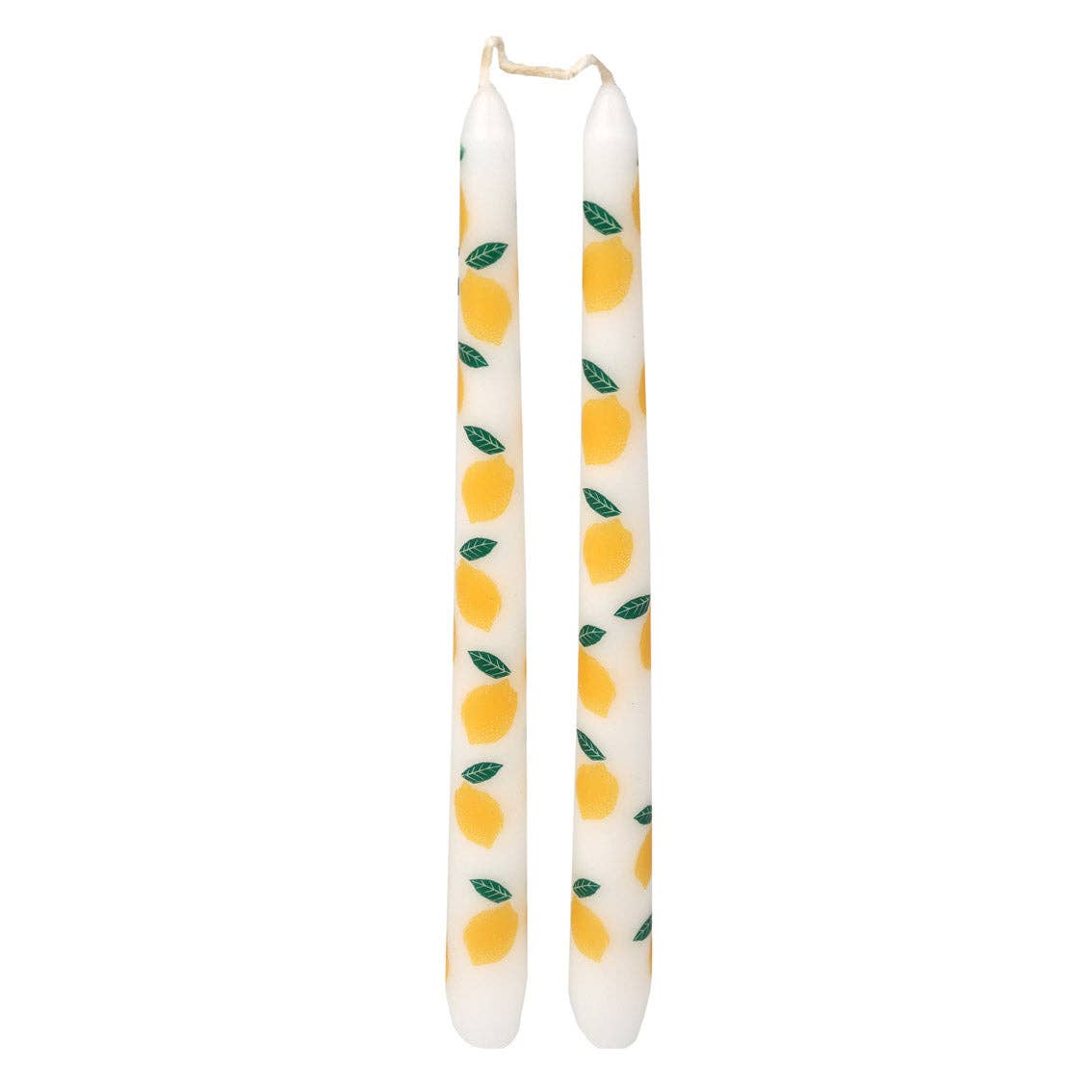 Two white candles with lemon pattern on a white background