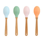 Four colorful spoons with wooden handles on a white background