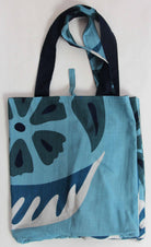 Tote bag with blue and black floral pattern on a white background