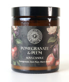Pomegranate & Plum soy candle with decorative label on a white background