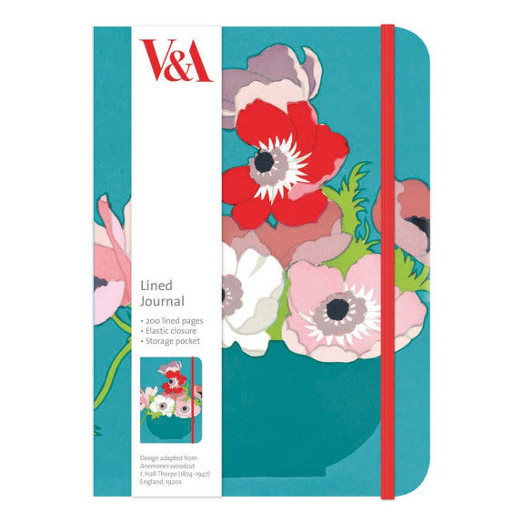 Image of a lined paper journal, showing the front cover which is turquoise with an anemone flower design in reds and pinks and a red elastic loop to keep the journal closed. There is a white paper strip to the left which gives details of the journal features. 
