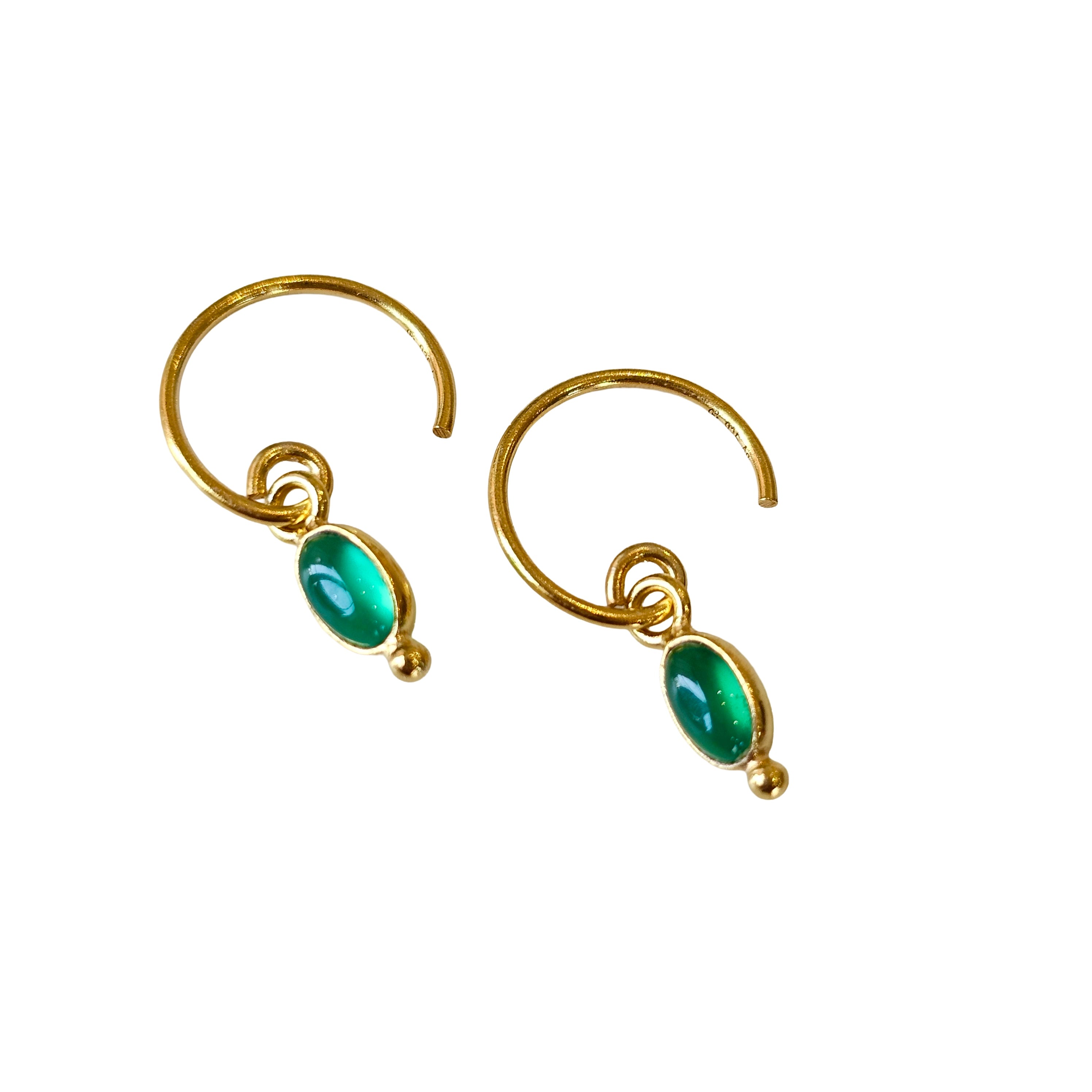 Gold earrings with agate gemstones on a white background
