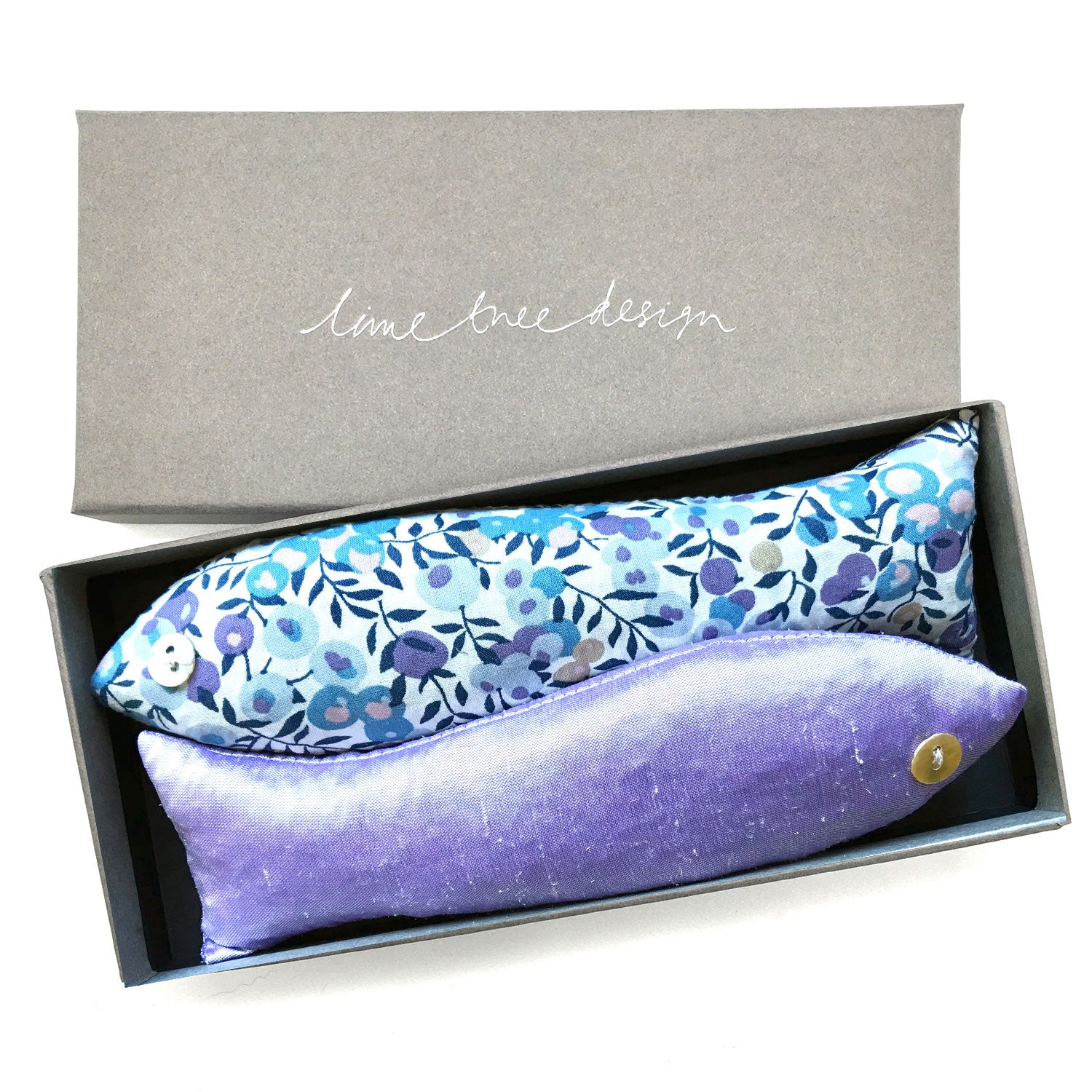 Lilac floral-patterned lavender fish shaped sachets in a box with 'Lime Tree Design' branding.