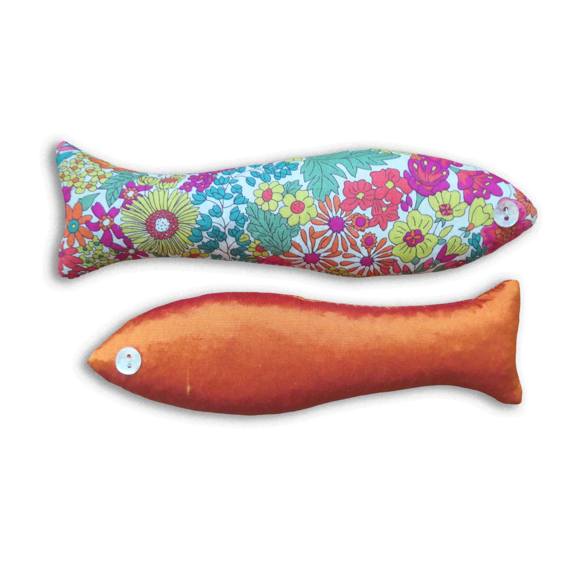 Two orange and green floral-patterned fish-shaped sachets on a white background