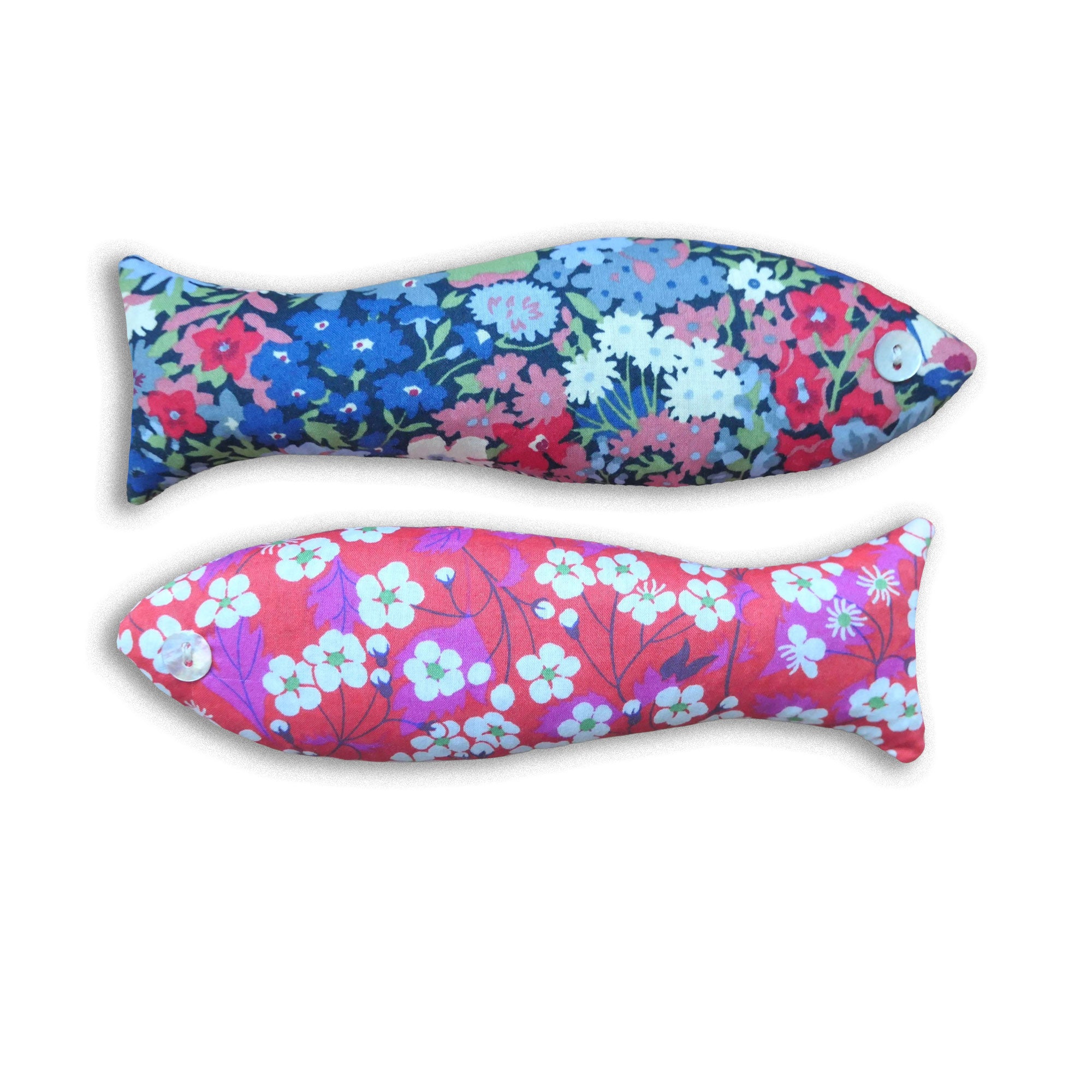 Two pink and blue floral-patterned fish-shaped sachets on a white background