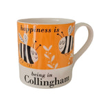 Mug with bee design and text 'happiness is being in Collingham' on an orange background