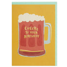 Greetings card featuring a pint mug of beer on a mustard yellow background. Reads “Cheers to your birthday” in gold embossing. Shown with a mint green envelope. 