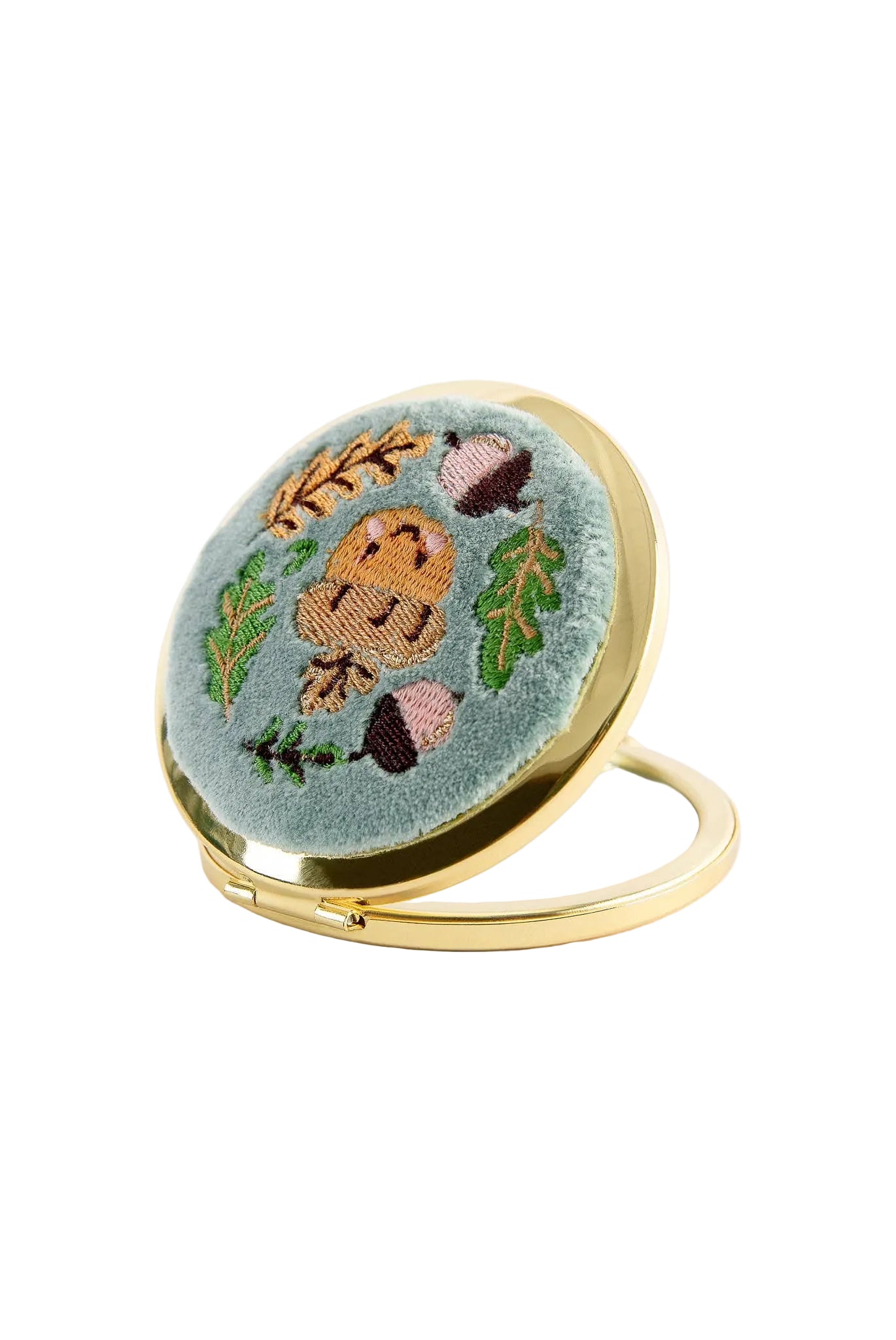 Compact mirror with embroidered design on a white background
