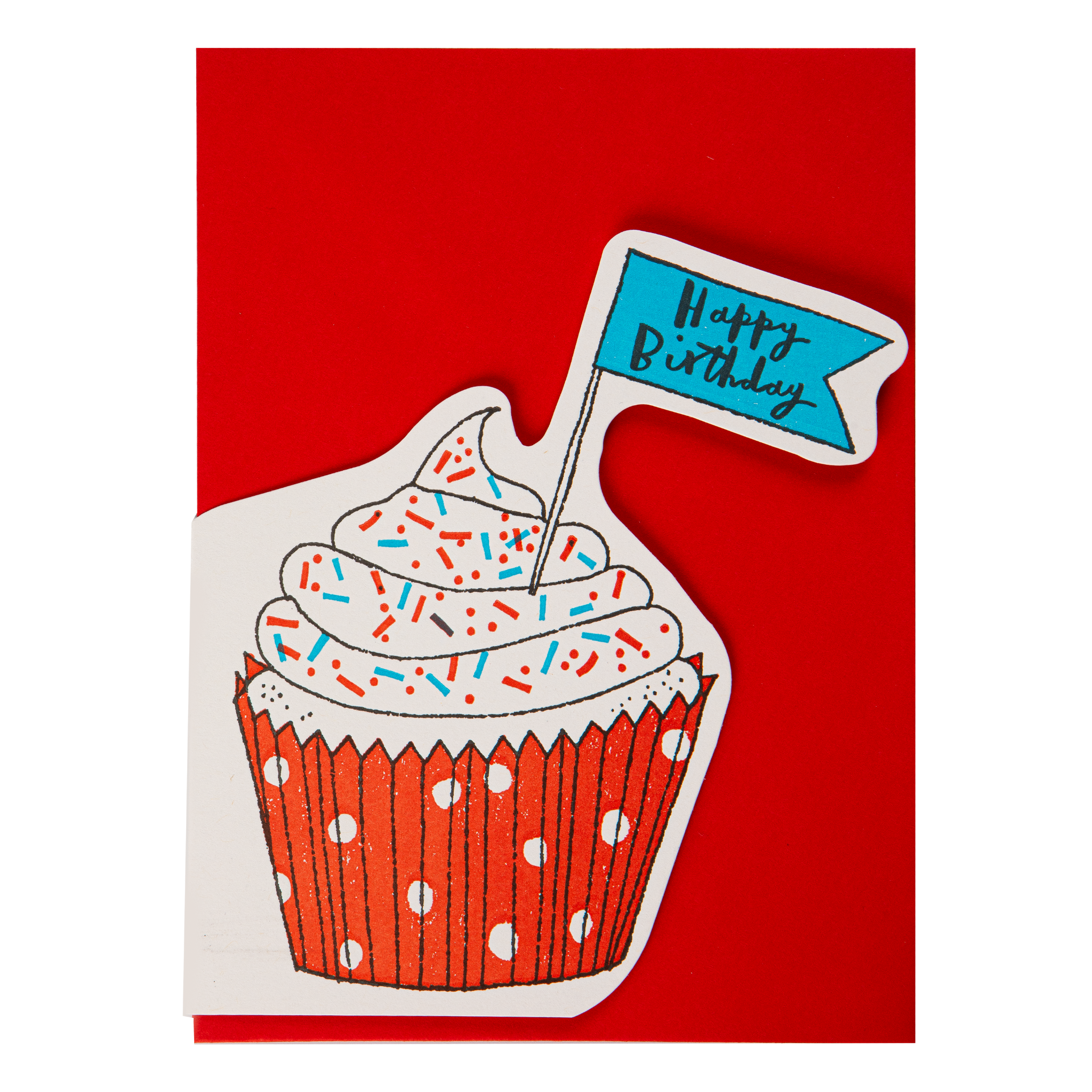 A birthday card featuring a stylized cupcake illustration with white frosting, multicolored sprinkles, a red polka-dot wrapper, and a small blue flag topper that reads 'Happy Birthday' in black script, set against a solid red envelope.
