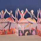 Colourful paper concertina card of dancers against a blue background