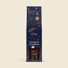 S'Eval Orange & Cinnamon reed diffuser in its dark navy blue packaging box, decorated with gold celestial illustrations like a crescent moon, stars, and a compass.