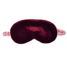 A plush velvet sleep mask in deep burgundy with a light pink elastic strap, shown against a plain white background.