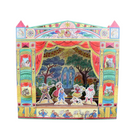 A colorful 3D pop-up cardboard theater set featuring a detailed stage backdrop with a fountain and trees, red curtains, and multiple cutout paper characters on a stage floor, photographed against a plain beige background.