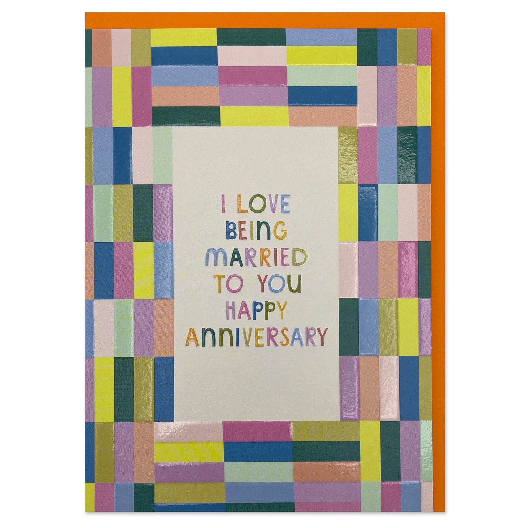 Bold and colourful anniversary card. Reads “I LOVE BEING MARRIED TO YOU HAPPY ANNIVERSARY”. With a colourful block pattern border. 