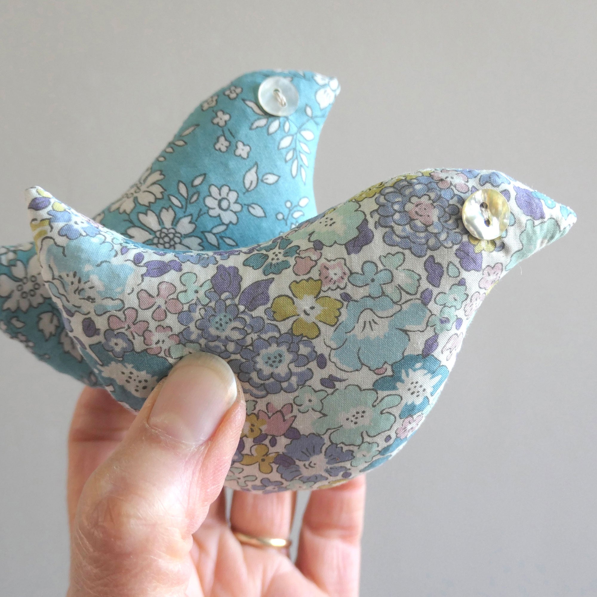 Two lavender birds in lilac and blue floral Liberty fabric