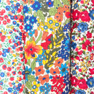Three cotton hankies in red, blue and yellow Liberty prints.