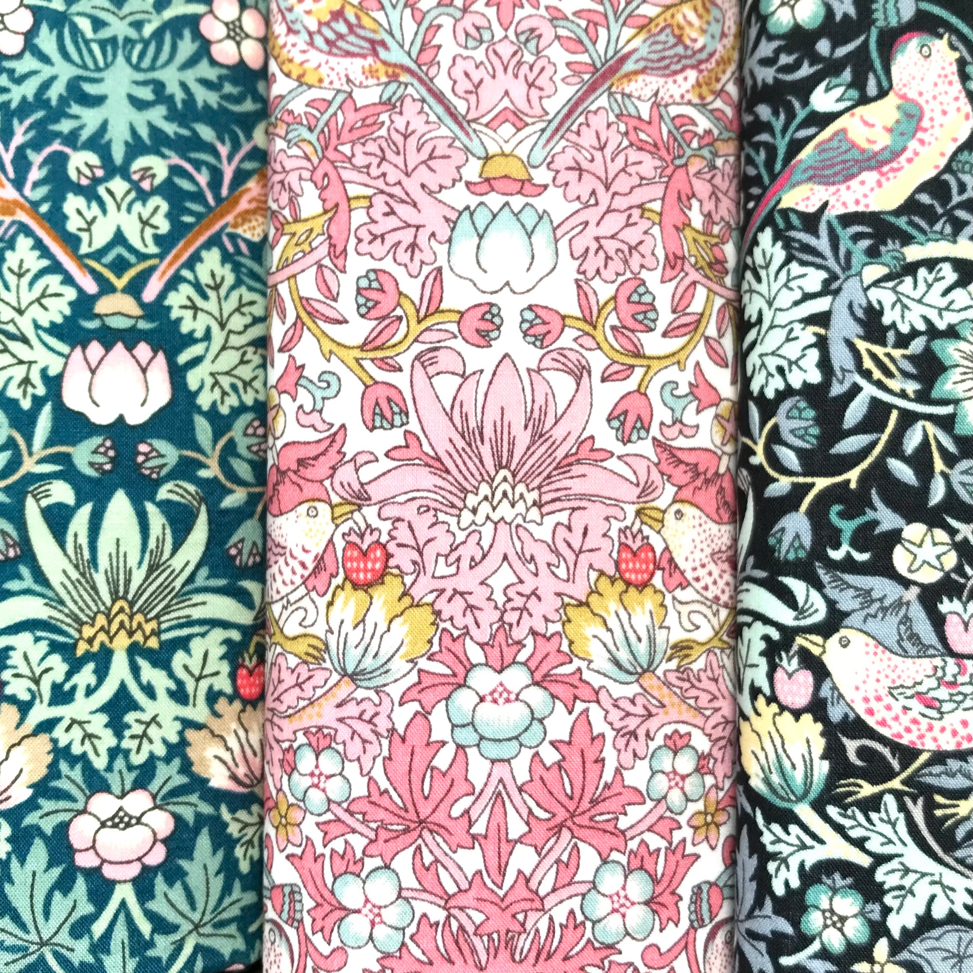 Three cotton hankies with floral and nature-themed patterns.