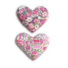 Two heart-shaped floral lavender sachets on a white background
