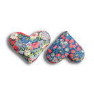 Two heart-shaped floral cushions on a white background