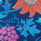 Floral and leaf pattern with pink flowers, blue leaves, and purple berries on a dark blue background.