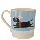 White mug featuring a black dog on a blue background design