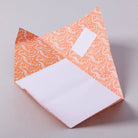 Decorative orange and white patterned letter paper on a plain background