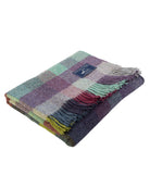 Multicolored checkered blanket with fringes on a white background