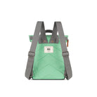 Back view of a green backpack with grey straps on a white background showing padded back and adjustable straps
