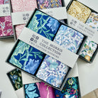 Box of The Morris Collection cotton hankies with floral patterns.
