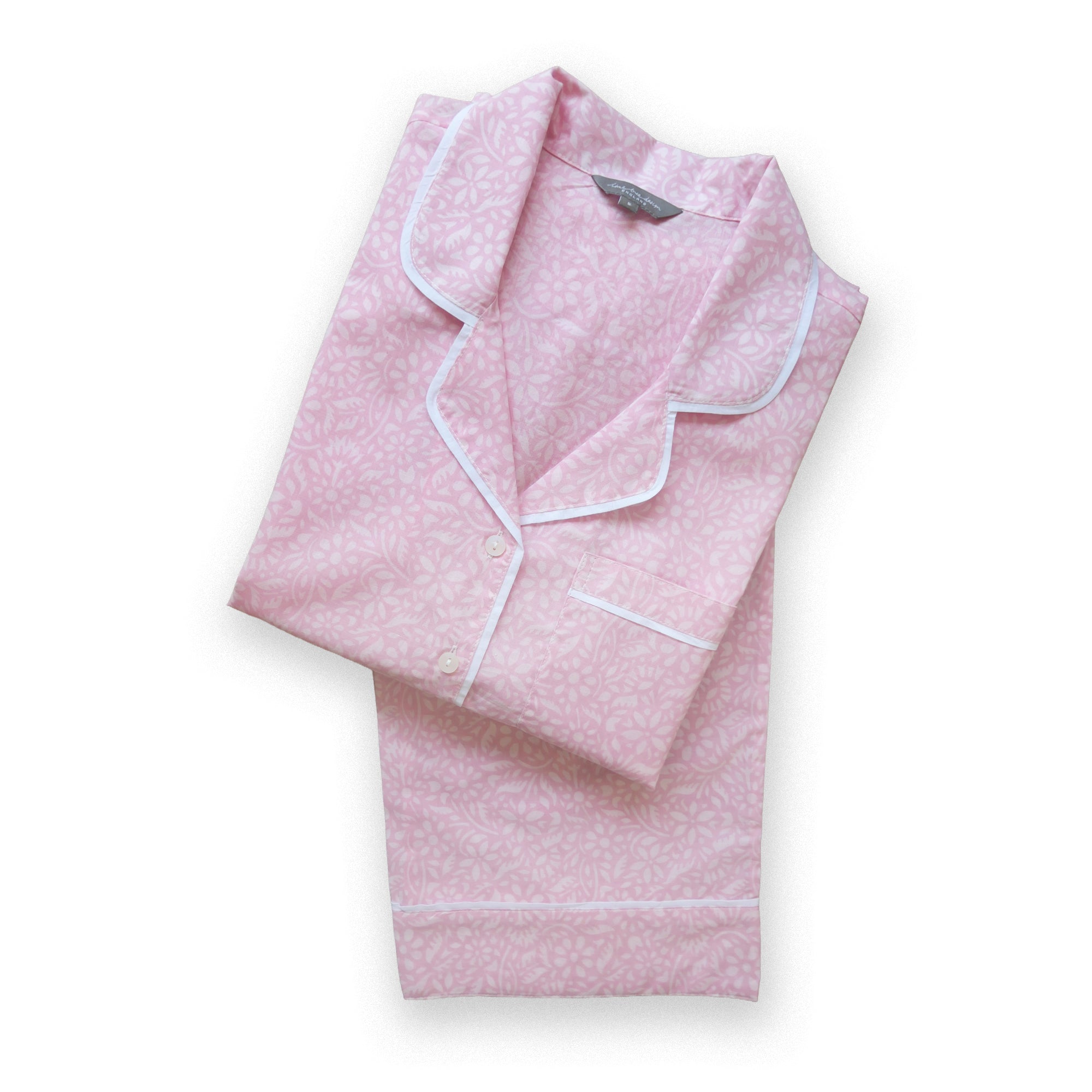 Pink pyjama with white piping on a white background
