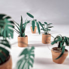 Small potted paper plants on a neutral background