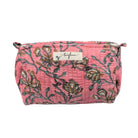 Floral patterned makeup bag with a brand label on a white background