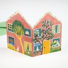 Colourful red house greetings card with detailed windows and doors on a white background