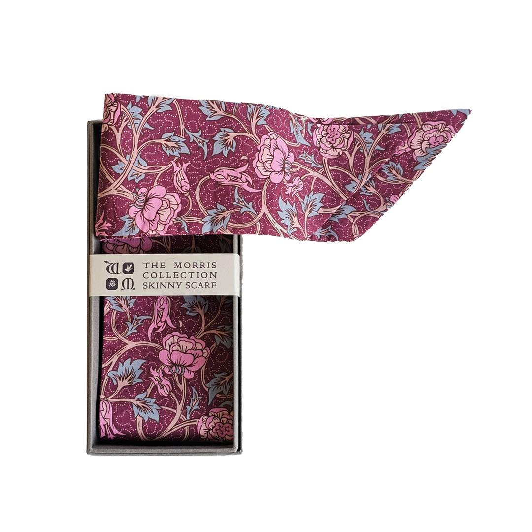 Floral scarf trailing out of grey box. 