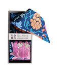 A floral skinny scarves in a box with a visible brand label.