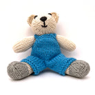 knitted soft toy polar bear in blue dungarees