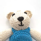 knitted soft toy polar bear in blue dungarees