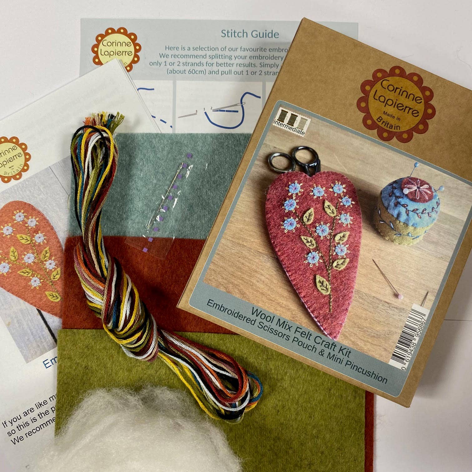 Kraft packaging with final product image, colourful threads, needle, red, green and blue felt sheets and an instructions sheet. 