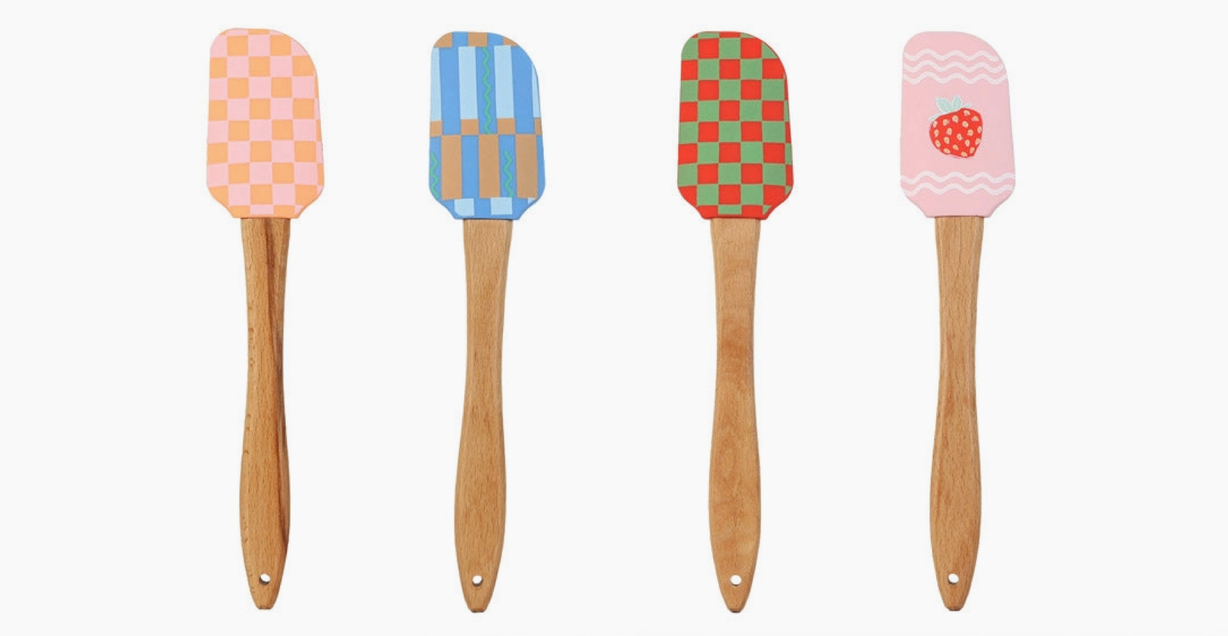 Four colorful spatulas with wooden handles on a white background