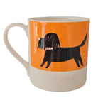 Mug with a black dog illustration on an orange background