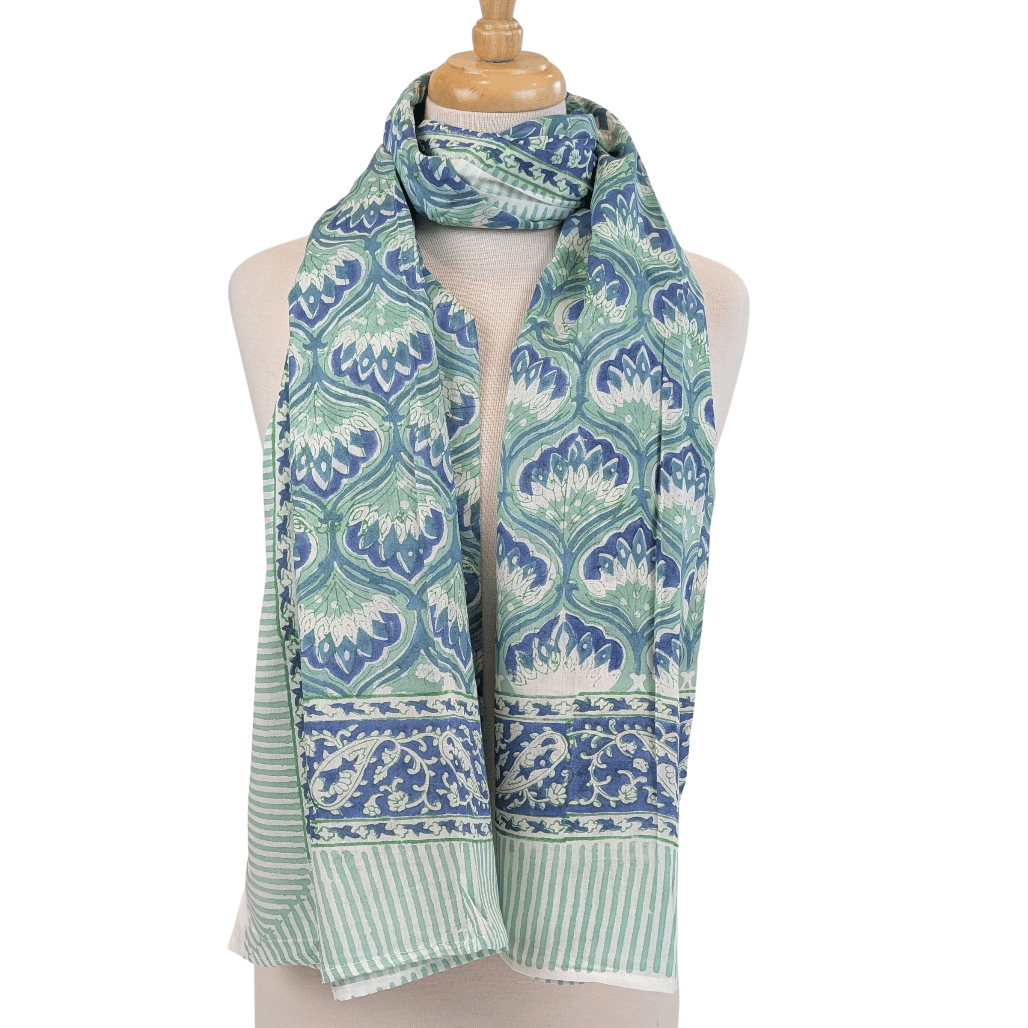 Green and blue patterned scarf on a mannequin against a white background