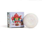 White spherical soap with teapot design next to a colourful box on a white background