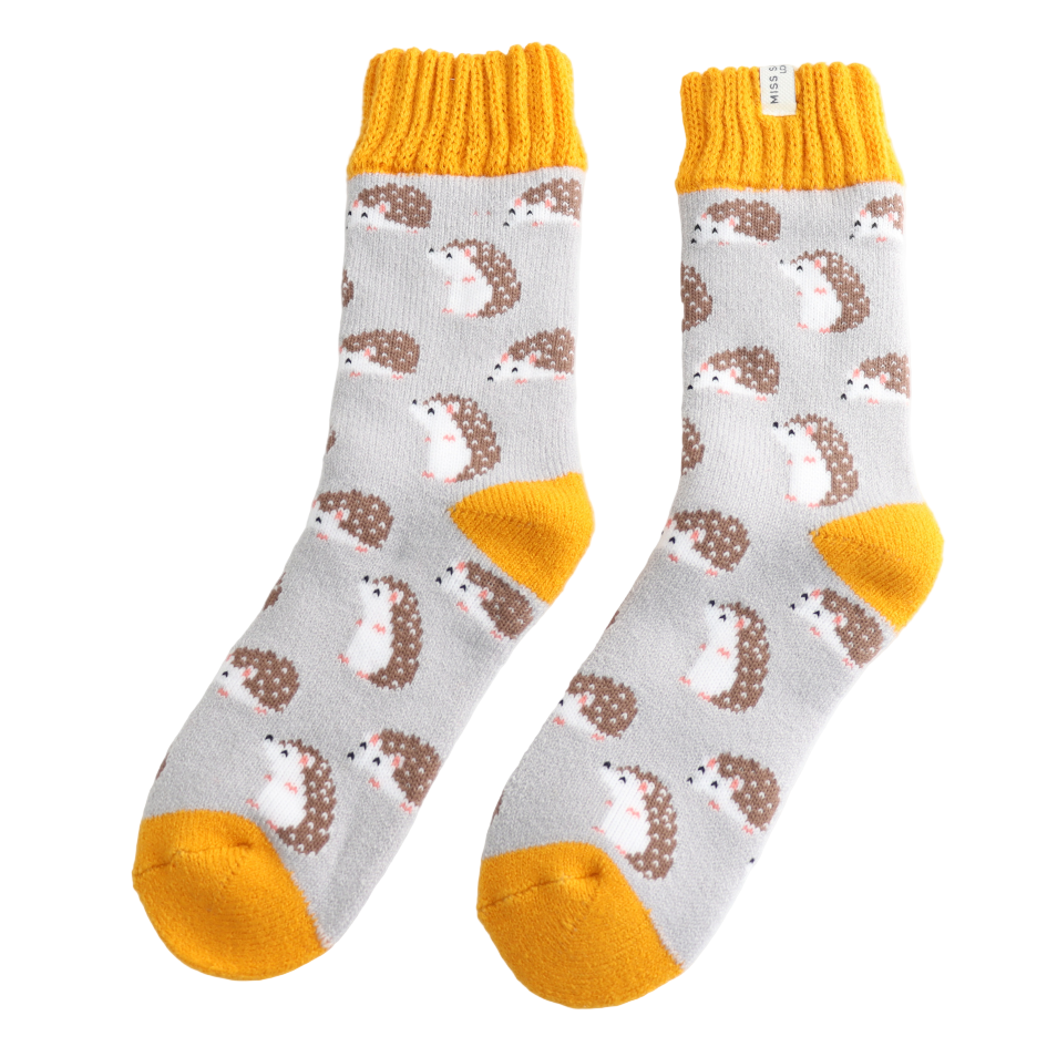 Pair of socks with hedgehog pattern and yellow accents on a white background