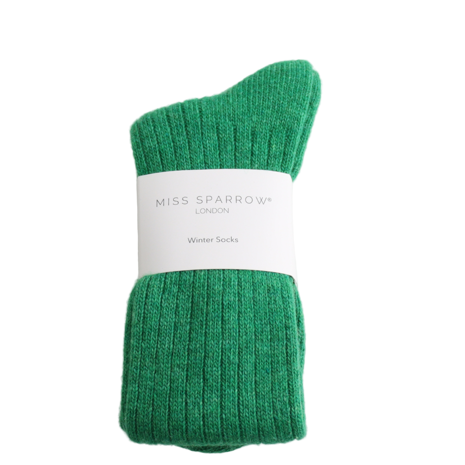 Green winter socks on a white background with 'Miss Sparrow London' label.
